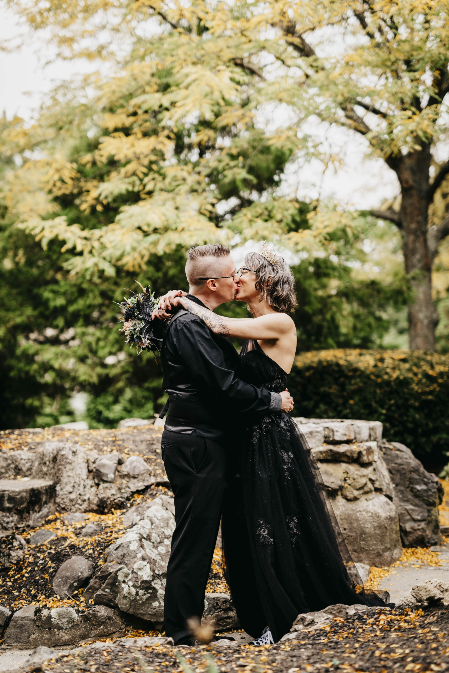two brides kissing each other at Greenlawn Cemetery in Salem Massachusetts