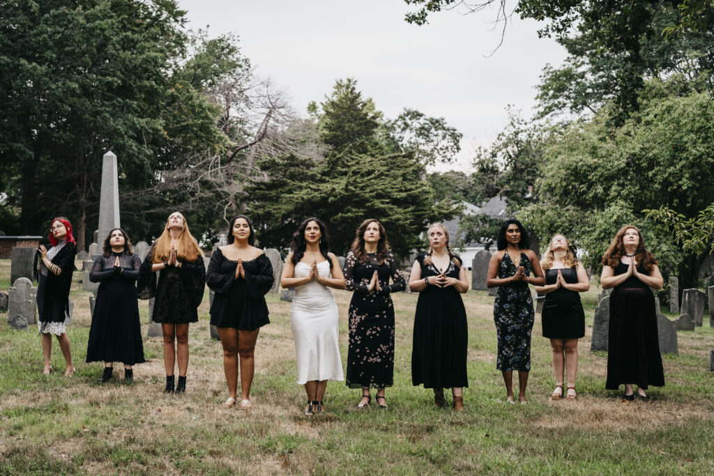 a group of girls pose at a cemetery in Salem Massachusetts
