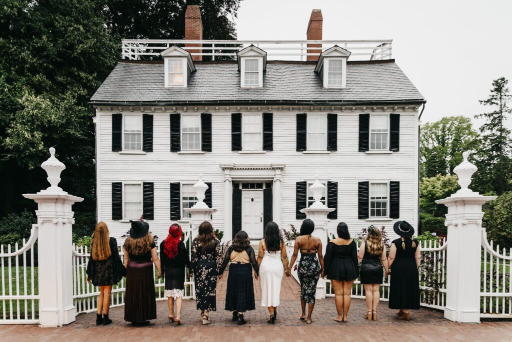 A group of girls pose in front of the Ropes Mansion in Salem Massachusetts