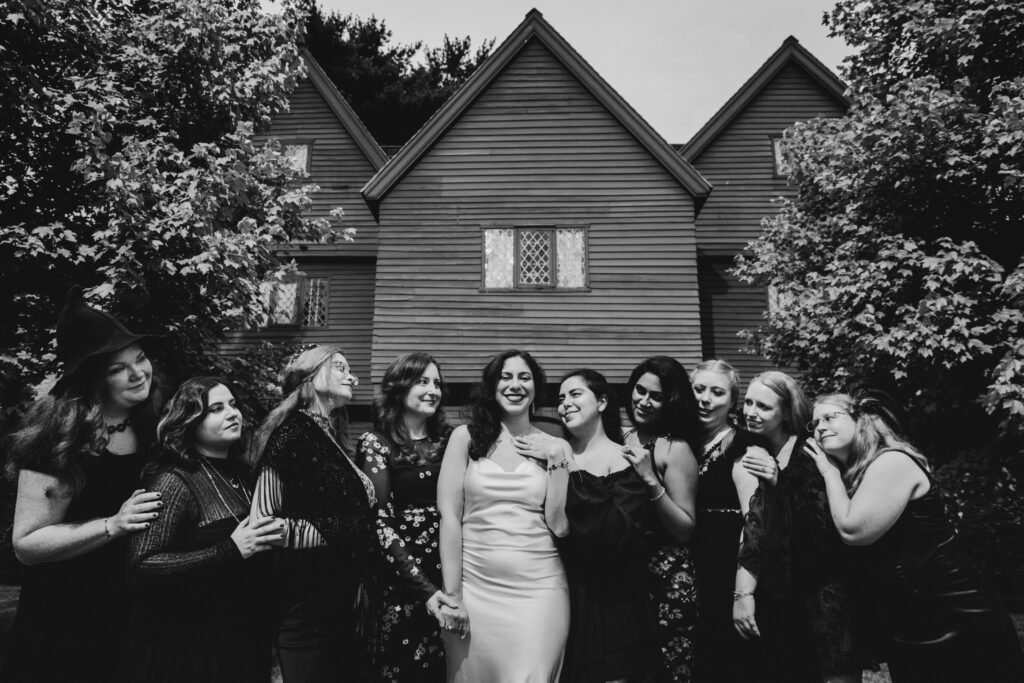A group of girls pose in front of the Witch House in Salem Massachusetts